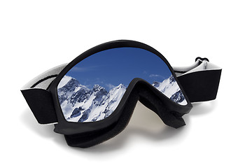 Image showing Ski goggles with reflection of snowy mountains