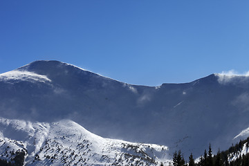 Image showing Winter mountains at sunny windy day