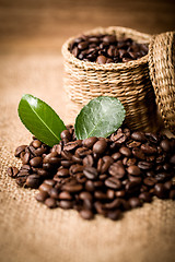 Image showing pile of fresh beans and green leaves and spoon in jar