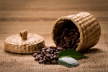 Image showing pile of fresh beans and green leaves and spoon in jar