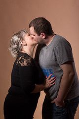 Image showing Beautiful xxl woman kissing her husband