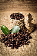 Image showing pile of fresh beans and green leaves and spoon in jar