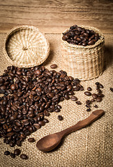 Image showing pile of fresh and bio aromatic coffee beans and spoon and jar