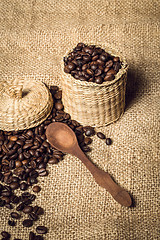 Image showing pile of fresh and bio aromatic coffee beans and spoon and jar