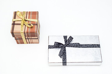 Image showing brown and silver gift box with bow on white background