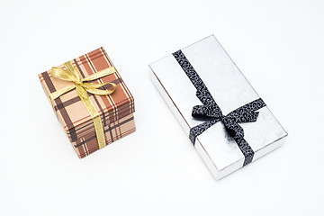 Image showing brown and silver gift box with bow on white background