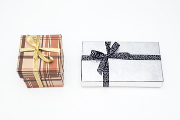 Image showing brown and silver gift box with bow on white background