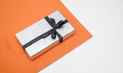 Image showing silver gift box with bow on white background