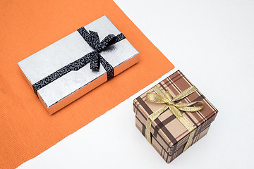 Image showing brown and silver gift box with bow on white background