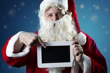 Image showing Portrait Santa Claus pointing on slate