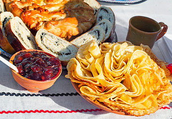 Image showing Pancakes and muffins on the table.