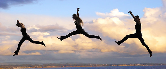 Image showing Leaping woman at sunset