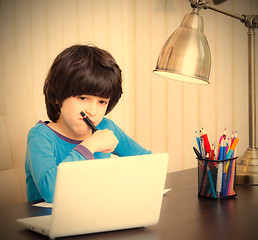 Image showing boy doing homework with computer