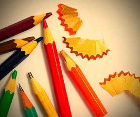 Image showing several vintage pencils and shavings on white