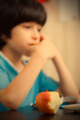 Image showing bitten apple and a boy with computer