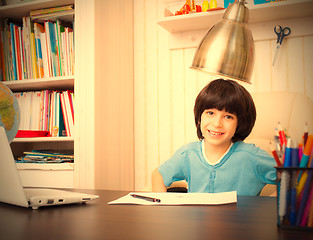 Image showing smiling schoolboy doing homework