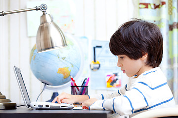 Image showing schoolboy working on a computer