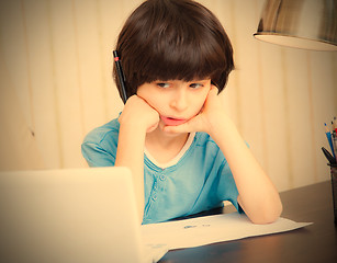 Image showing boy looks thoughtfully at the display