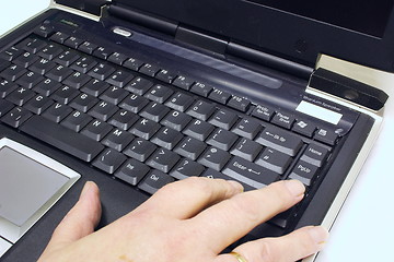 Image showing finger on the keys of a  laptop keyboard