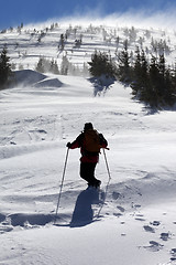 Image showing Hiker in winter mountains at sunny windy day