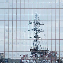 Image showing electric pole reflected in windows of office building