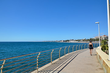 Image showing Woman walking at the coastal promenade