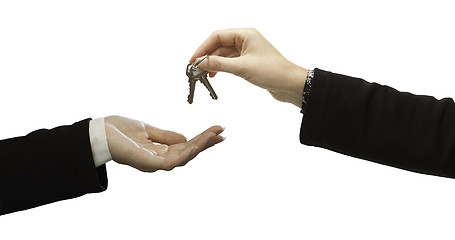 Image showing Woman Handing Over Woman Set Of Keys Isolated on White