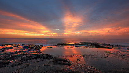 Image showing Streaks of orange red light at sunrise Curl Curl