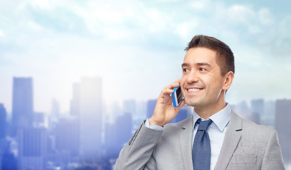 Image showing happy businessman calling on smartphone