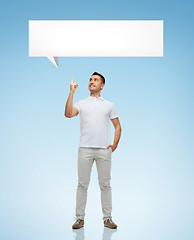 Image showing smiling man pointing finger up to text bubble