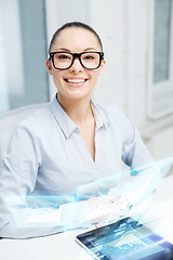 Image showing smiling businesswoman in eyeglasses with tablet pc