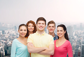 Image showing group of smiling teenagers over city background