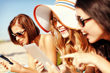 Image showing girls with tablet pc on the beach