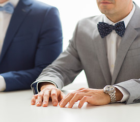 Image showing close up of happy male gay couple hands on wedding