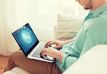 Image showing close up of man working with laptop at home