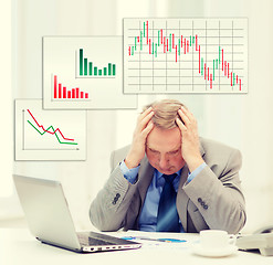 Image showing upset older businessman with laptop in office