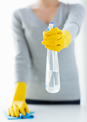 Image showing close up of woman cleaning table with cloth