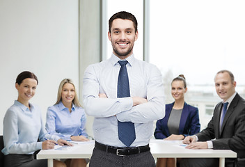 Image showing handsome businessman with crossed arms