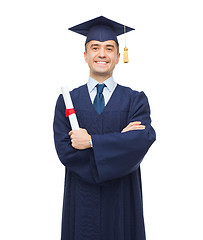 Image showing smiling adult student in mortarboard with diploma