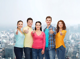 Image showing group of smiling teenagers over city background