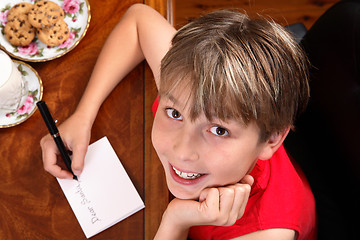 Image showing Child writing  a letter or card at Christmas
