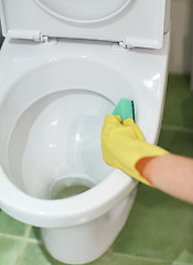 Image showing close up of hand with detergent cleaning toilet