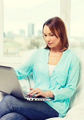 Image showing happy woman with laptop at home