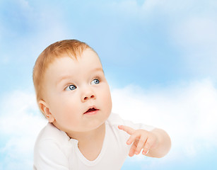 Image showing curious baby looking side