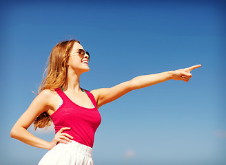 Image showing girl showing direction on the beach