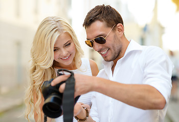 Image showing smiling couple with photo camera