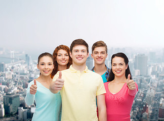 Image showing group of smiling teenagers over city background