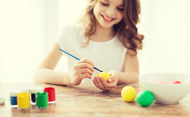 Image showing close up of girl coloring eggs for easter