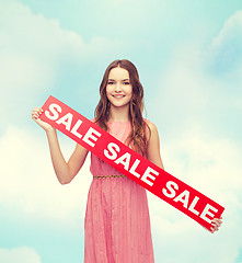 Image showing young woman in dress with sale sign