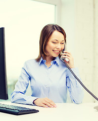 Image showing businesswoman with laptop and telephone